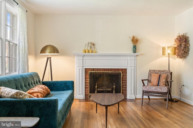 5600 11th St N, Arlington, VA 22205 - sitting room with wood finished floors, a brick fireplace, and baseboards