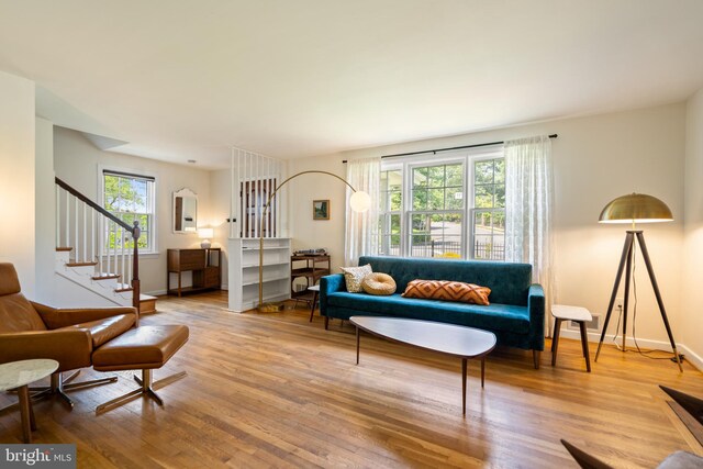 5600 11th St N, Arlington, VA 22205 - living room featuring healthy amount of natural light, wood finished floors, stairs, and baseboards