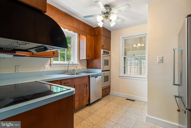 5600 11th St N, Arlington, VA 22205 - kitchen with appliances with stainless steel finishes, extractor fan, a sink, baseboards, and brown cabinetry