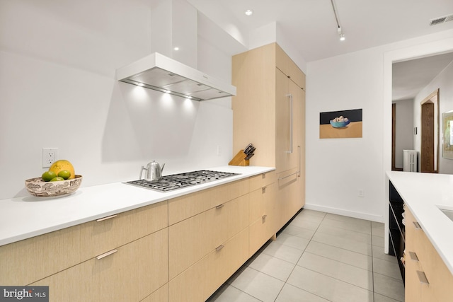 1800 Lamont St NW, Washington, DC 20010 - kitchen with stainless steel gas cooktop, wall chimney exhaust hood, light countertops, and light brown cabinets