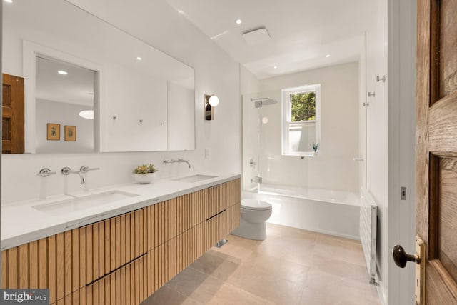 1800 Lamont St NW, Washington, DC 20010 - bathroom featuring toilet, double vanity, radiator heating unit, bathtub / shower combination, and tile patterned floors