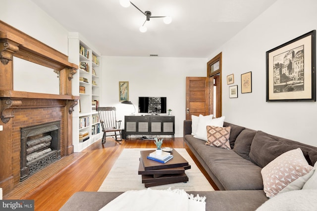 1800 Lamont St NW, Washington, DC 20010 - living area with light wood-style flooring and a brick fireplace