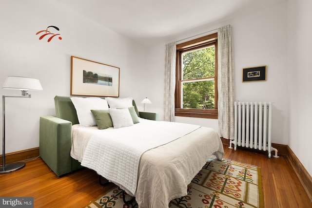 1800 Lamont St NW, Washington, DC 20010 - bedroom featuring radiator, wood finished floors, and baseboards