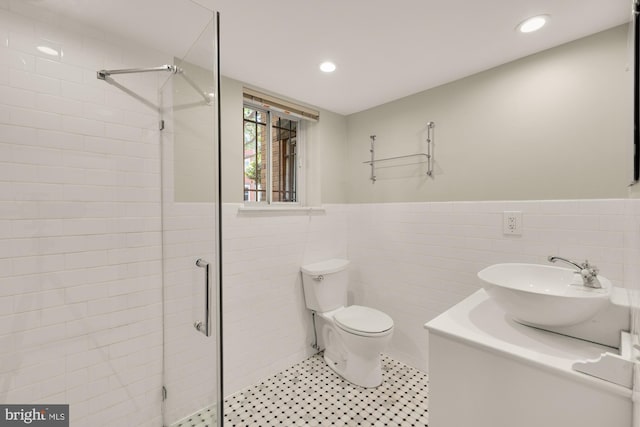1800 Lamont St NW, Washington, DC 20010 - full bathroom with tile walls, a shower stall, toilet, a wainscoted wall, and vanity