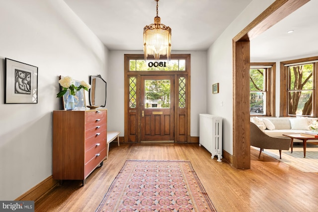 1800 Lamont St NW, Washington, DC 20010 - entryway featuring radiator, light wood-style floors, a chandelier, and baseboards