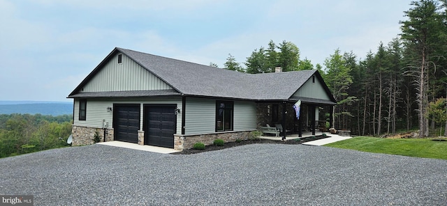 2204 Baker Mountain Dr, Yellow Spring, WV 26865 - view of front of property featuring covered porch, driveway, stone siding, roof with shingles, and an attached garage