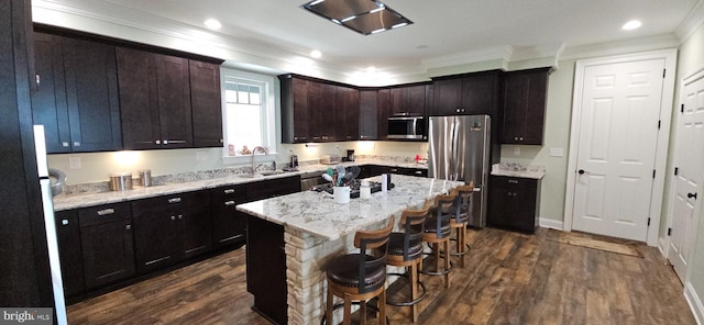 2204 Baker Mountain Dr, Yellow Spring, WV 26865 - kitchen featuring stainless steel appliances, ornamental molding, dark wood-type flooring, a kitchen bar, and a center island