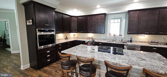 2204 Baker Mountain Dr, Yellow Spring, WV 26865 - kitchen featuring appliances with stainless steel finishes, crown molding, a kitchen bar, light stone counters, and dark wood-style floors