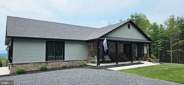 2204 Baker Mountain Dr, Yellow Spring, WV 26865 - back of house with stone siding, roof with shingles, board and batten siding, and a porch