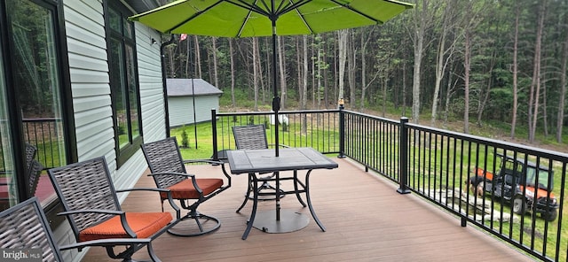 2204 Baker Mountain Dr, Yellow Spring, WV 26865 - wooden terrace with outdoor dining area, a yard, and a wooded view