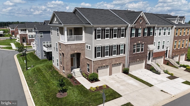 22277 Foggy Ridge Ter, Ashburn, VA 20148 - multi unit property featuring concrete driveway, brick siding, a garage, a front lawn, and a residential view