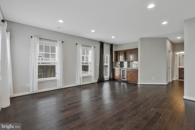 22277 Foggy Ridge Ter, Ashburn, VA 20148 - unfurnished living room featuring a bar, wine cooler, dark wood-type flooring, recessed lighting, and baseboards
