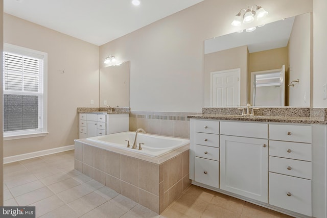 22277 Foggy Ridge Ter, Ashburn, VA 20148 - bathroom with tile patterned flooring, a bath, two vanities, and baseboards