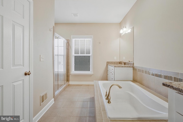 22277 Foggy Ridge Ter, Ashburn, VA 20148 - bathroom with vanity, a bath, a shower stall, and tile patterned floors