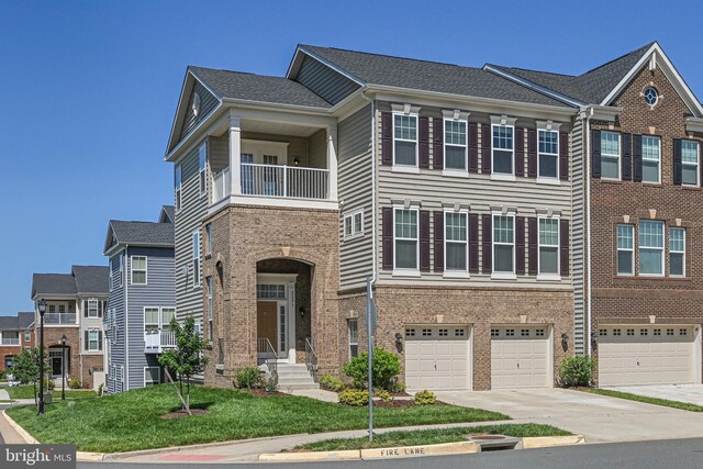 22277 Foggy Ridge Ter, Ashburn, VA 20148 - townhome / multi-family property featuring driveway, a garage, a balcony, brick siding, and a front yard