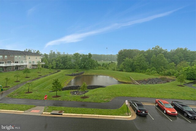 22277 Foggy Ridge Ter, Ashburn, VA 20148 - surrounding community with a water view, uncovered parking, and a yard