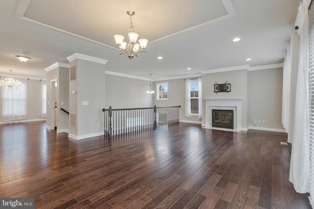 22277 Foggy Ridge Ter, Ashburn, VA 20148 - unfurnished living room featuring a chandelier, dark wood-type flooring, ornamental molding, recessed lighting, and a premium fireplace