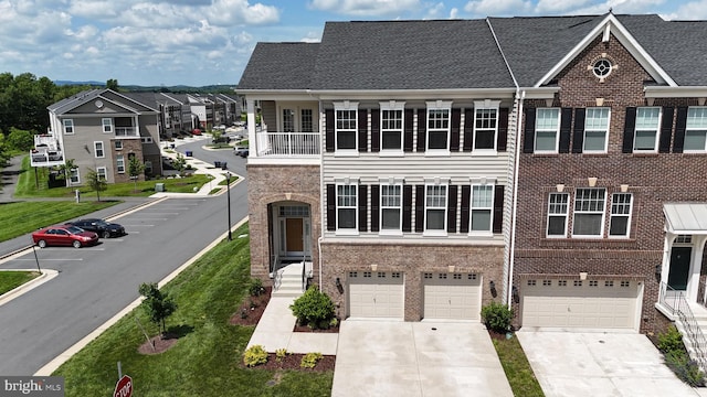 22277 Foggy Ridge Ter, Ashburn, VA 20148 - view of front of property with an attached garage, driveway, and brick siding