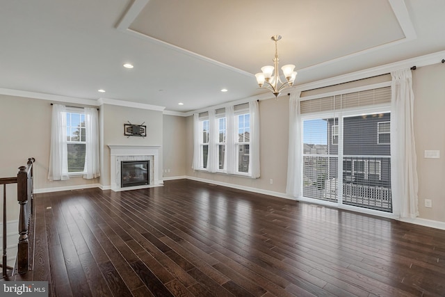 22277 Foggy Ridge Ter, Ashburn, VA 20148 - unfurnished living room with a chandelier, ornamental molding, healthy amount of natural light, a fireplace with flush hearth, and dark wood-style floors