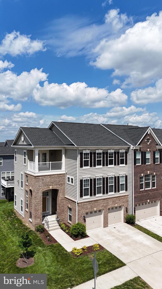 22277 Foggy Ridge Ter, Ashburn, VA 20148 - townhome / multi-family property with an attached garage, driveway, a balcony, and a front yard