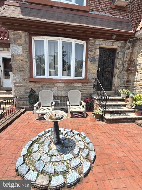 7316 Pittville Ave, Philadelphia, PA 19126 - view of exterior entry with a patio area and stone siding