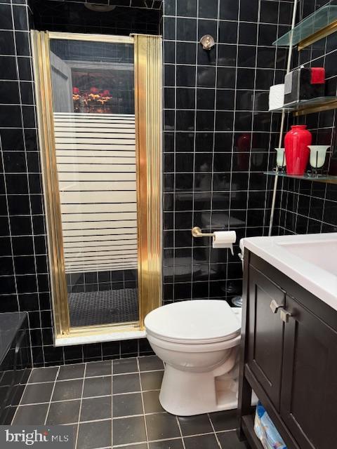 7316 Pittville Ave, Philadelphia, PA 19126 - full bathroom with tile patterned flooring, tile walls, a shower stall, vanity, and toilet