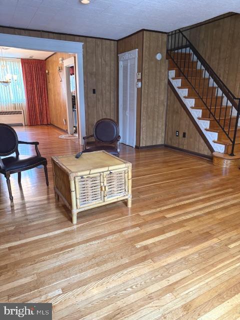7316 Pittville Ave, Philadelphia, PA 19126 - living room featuring hardwood / wood-style flooring, stairway, and wooden walls