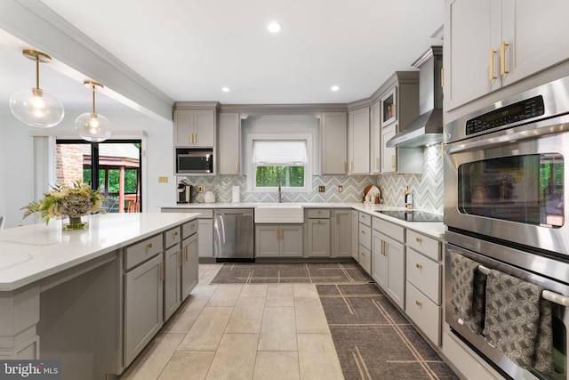 15713 Holly Grove Rd, Silver Spring, MD 20905 - kitchen with gray cabinets, appliances with stainless steel finishes, decorative backsplash, a sink, and wall chimney range hood