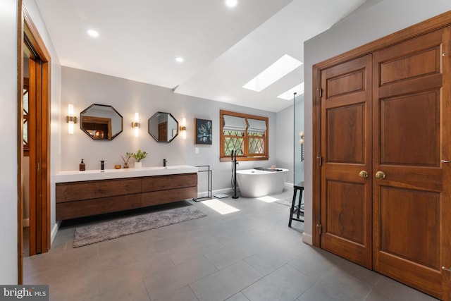 15713 Holly Grove Rd, Silver Spring, MD 20905 - full bath with a skylight, double vanity, baseboards, a soaking tub, and recessed lighting