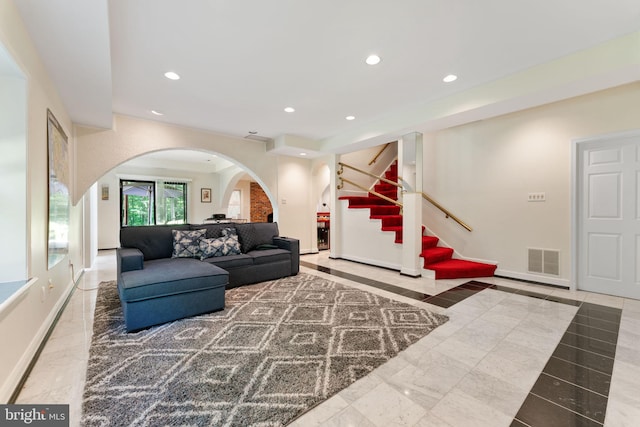 15713 Holly Grove Rd, Silver Spring, MD 20905 - living area with arched walkways, recessed lighting, stairway, and baseboards