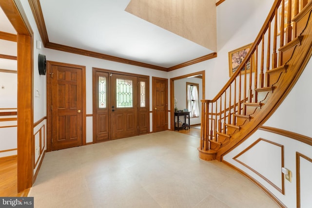 15713 Holly Grove Rd, Silver Spring, MD 20905 - foyer entrance featuring stairs, crown molding, wainscoting, and tile patterned floors
