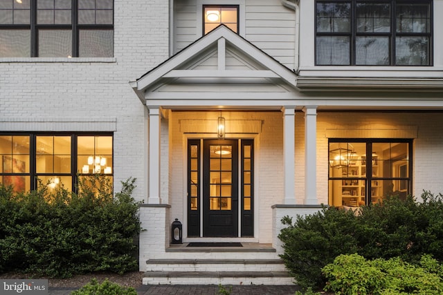 717 Miller Ave, Great Falls, VA 22066 - doorway to property with brick siding and covered porch