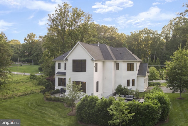 717 Miller Ave, Great Falls, VA 22066 - view of front of home with a patio area, a front yard, an outdoor living space, and roof with shingles