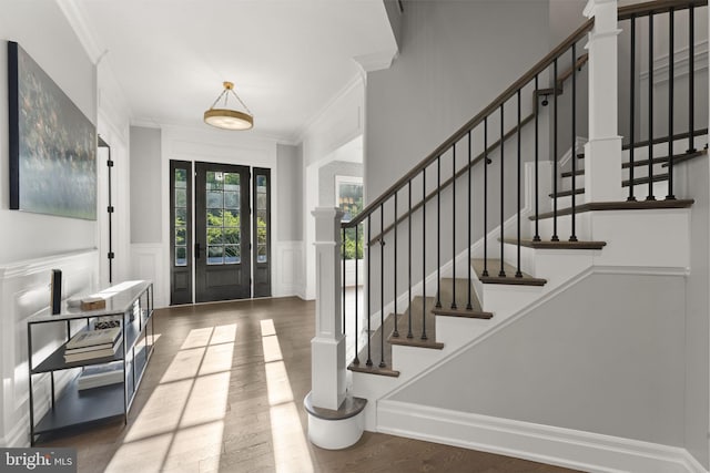 717 Miller Ave, Great Falls, VA 22066 - entrance foyer with ornamental molding, a decorative wall, wood finished floors, a wainscoted wall, and stairs