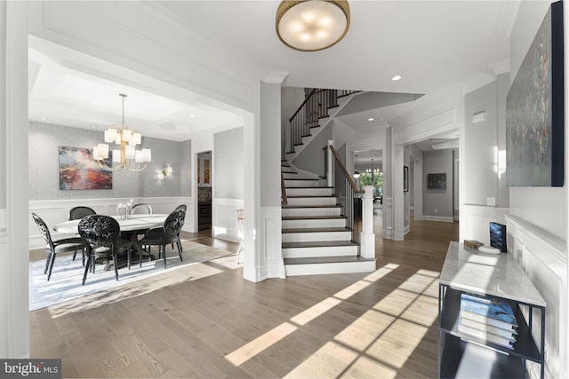 717 Miller Ave, Great Falls, VA 22066 - dining space featuring a chandelier, light wood-style floors, stairway, a decorative wall, and wainscoting