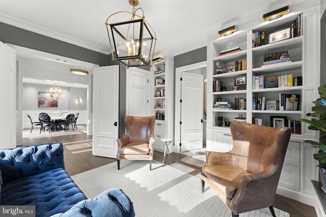 717 Miller Ave, Great Falls, VA 22066 - living area with a chandelier, crown molding, wood finished floors, a decorative wall, and built in shelves