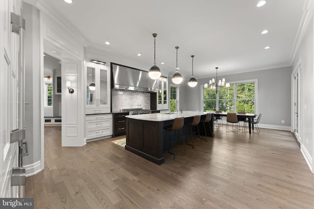 717 Miller Ave, Great Falls, VA 22066 - kitchen featuring range hood, crown molding, light wood-style floors, recessed lighting, and decorative backsplash