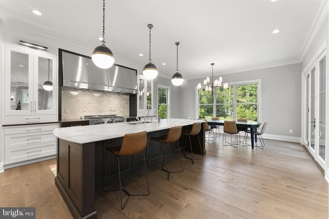 717 Miller Ave, Great Falls, VA 22066 - kitchen featuring ventilation hood, decorative backsplash, plenty of natural light, glass insert cabinets, and ornamental molding