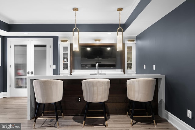 717 Miller Ave, Great Falls, VA 22066 - bar area featuring ornamental molding, light wood-style flooring, pendant lighting, and refrigerator