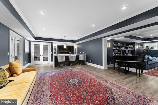 717 Miller Ave, Great Falls, VA 22066 - living room featuring wood finished floors, ornamental molding, bar area, french doors, and recessed lighting