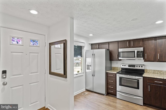 13825 Palmer House Way Unit 32-237, Silver Spring, MD 20904 - kitchen with appliances with stainless steel finishes, dark brown cabinetry, light wood-style flooring, a textured ceiling, and recessed lighting