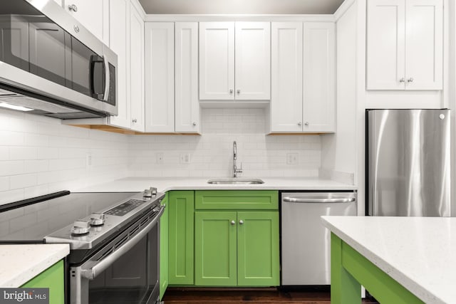 7229 Georgia Ave NW Unit A, Washington, DC 20012 - kitchen with appliances with stainless steel finishes, a sink, green cabinets, and white cabinetry