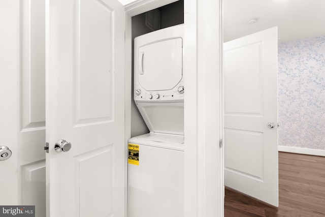 7229 Georgia Ave NW Unit A, Washington, DC 20012 - laundry area with stacked washing machine and dryer, dark wood-style floors, and baseboards