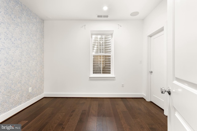 7229 Georgia Ave NW Unit A, Washington, DC 20012 - spare room featuring wallpapered walls, dark wood-type flooring, and baseboards