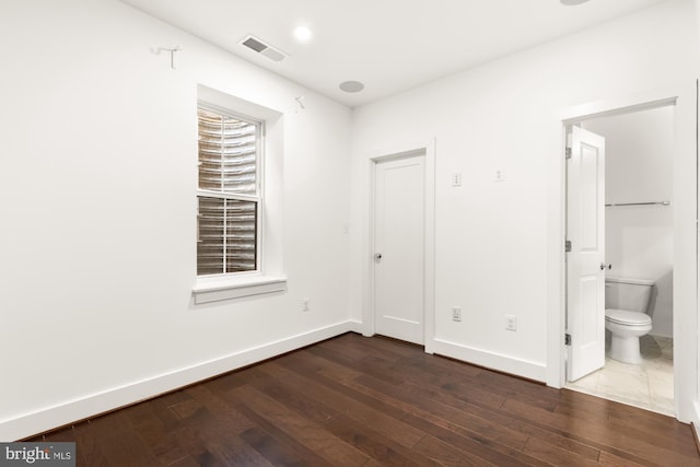 7229 Georgia Ave NW Unit A, Washington, DC 20012 - unfurnished bedroom featuring dark wood-style flooring, baseboards, and ensuite bath
