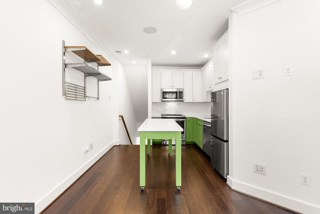 7229 Georgia Ave NW Unit A, Washington, DC 20012 - kitchen with stainless steel appliances, a center island, baseboards, white cabinetry, and recessed lighting
