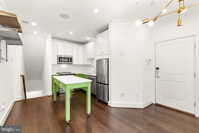7229 Georgia Ave NW Unit A, Washington, DC 20012 - kitchen with stainless steel appliances, light countertops, white cabinets, dark wood finished floors, and decorative backsplash