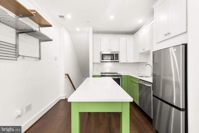 7229 Georgia Ave NW Unit A, Washington, DC 20012 - kitchen with appliances with stainless steel finishes, a sink, white cabinets, light countertops, and recessed lighting