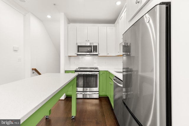 7229 Georgia Ave NW Unit A, Washington, DC 20012 - kitchen with stainless steel appliances, green cabinetry, light countertops, dark wood-style floors, and white cabinetry