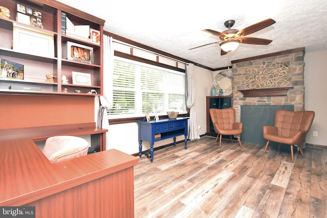 8755 Cather Ave, Manassas, VA 20110 - living area featuring a textured ceiling, wood finished floors, ceiling fan, and a fireplace